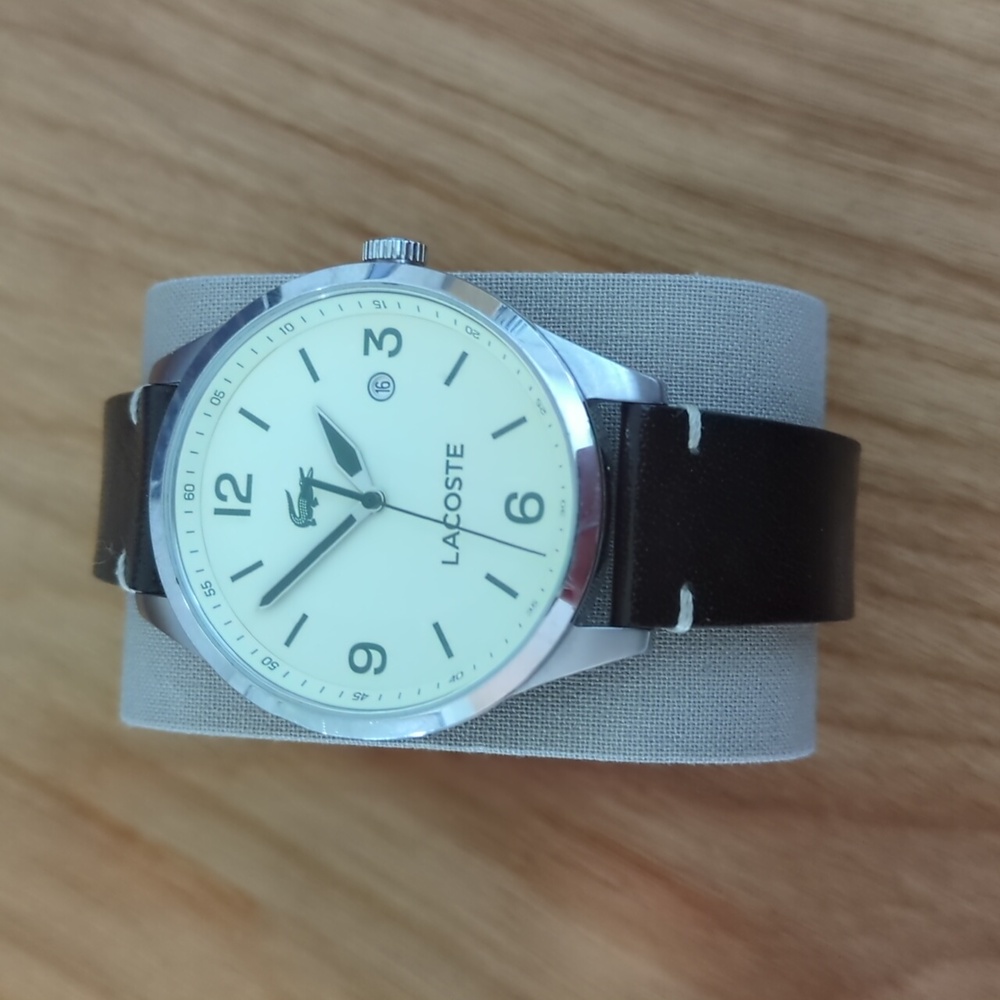 Lacoste watch, brown leather strap, cream face, green accents